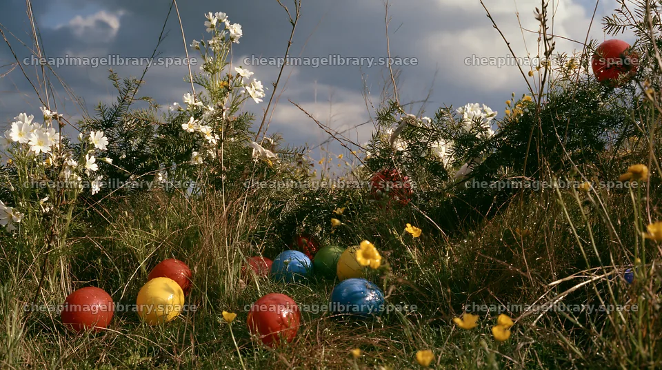 Christmas garlands in meadow under dramatic clouds and light – image library 10608x5938