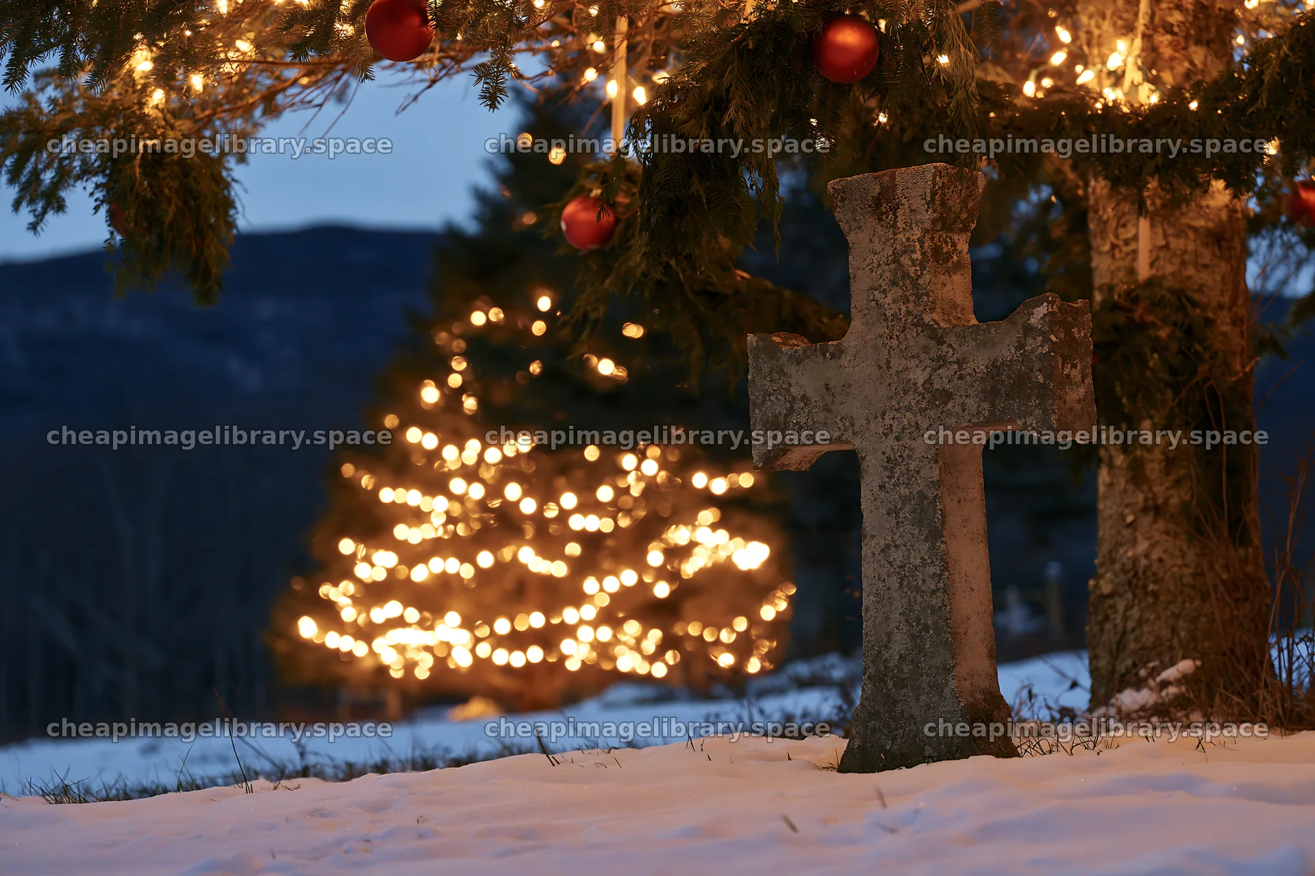 Weathered Christian cross in snowy meadow with lights in background – image library 9722x6480