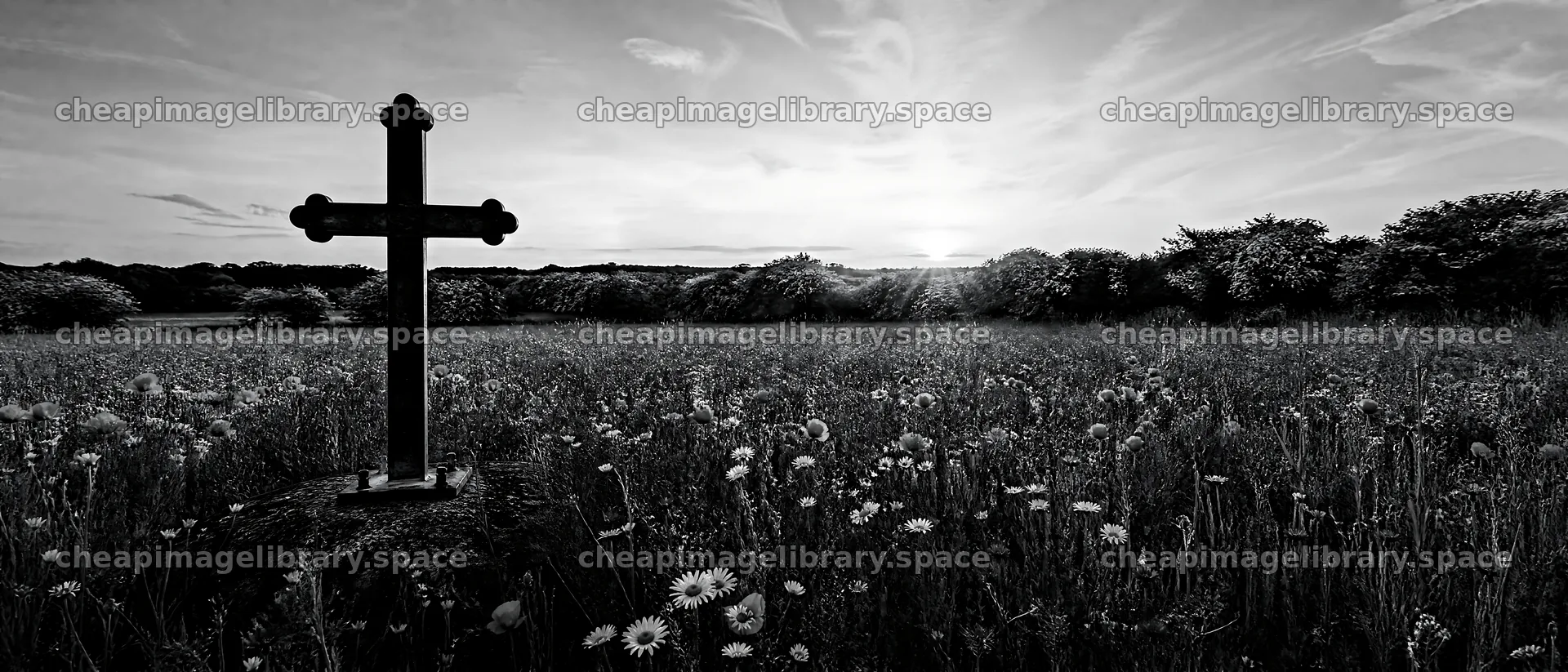 Rustic Christian cross in a spring meadow at sunset – image library 12124x5196