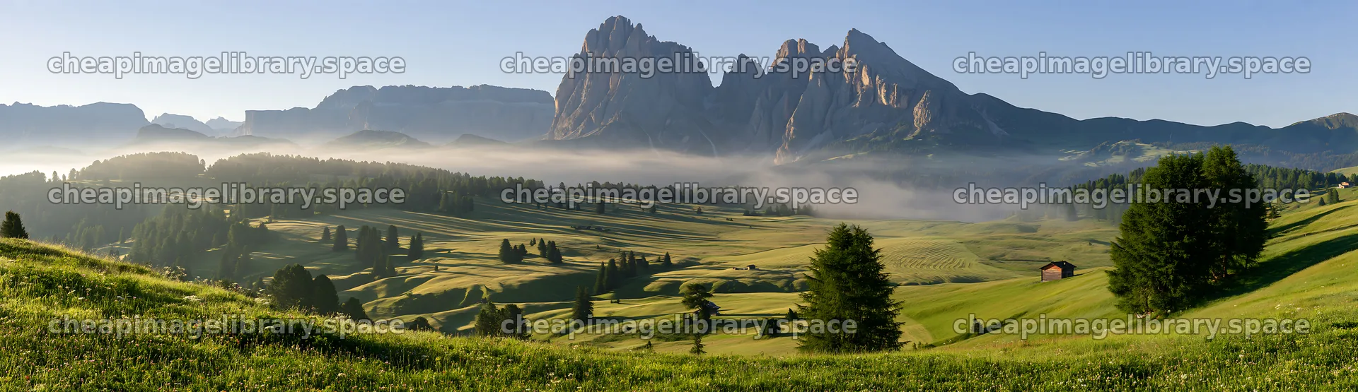 Sunbeams over Alpe di Siusi meadow in the morning – image library 14762x4268