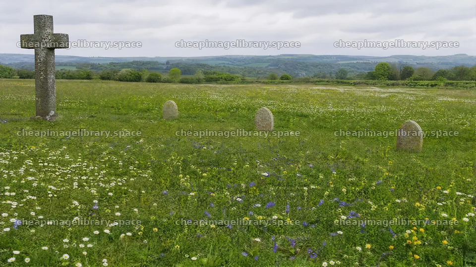 Rustic Christian cross in spring meadow with distant hills – image library 10584x5952