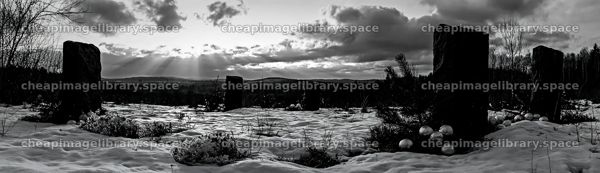 Snowy meadow with Christmas ornaments under rays from clouds – image library 14762x4268