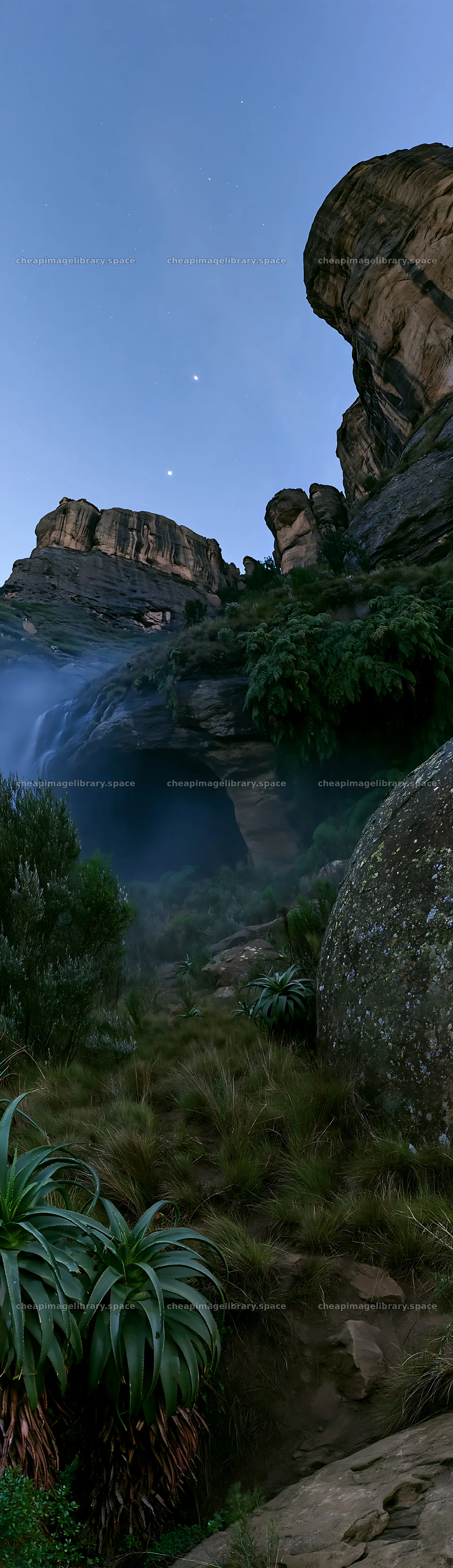 Moonlit meadow with rocks and waterfall in evening light – image library 4268x14762