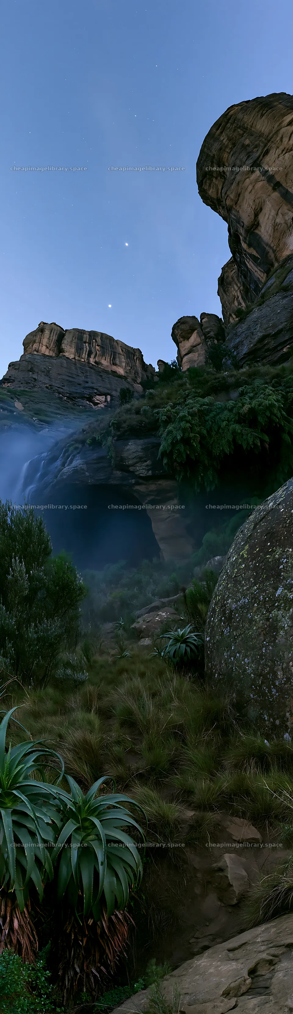 Moonlit meadow with rocks and waterfall in evening light – image library 4268x14762