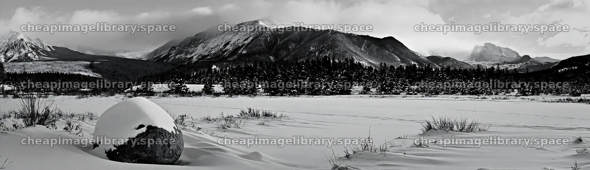 Snowy rocky mountain park meadow with distant peaks – image library 14762x4268