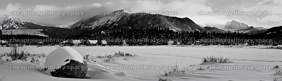 Snowy rocky mountain park meadow with distant peaks – image library 14762x4268
