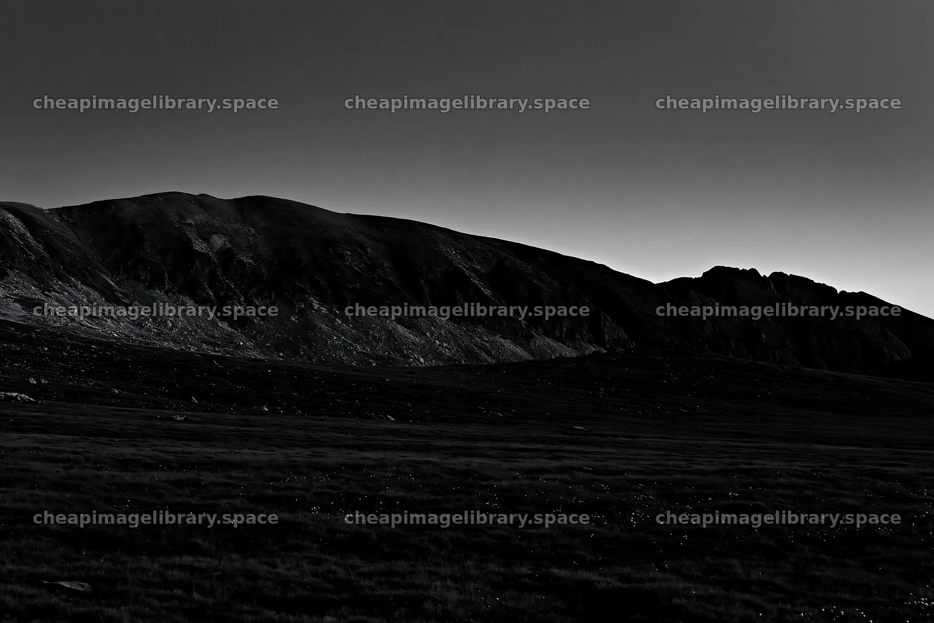 Moonrise over meadow with mountains in silhouette – image library 9722x6480