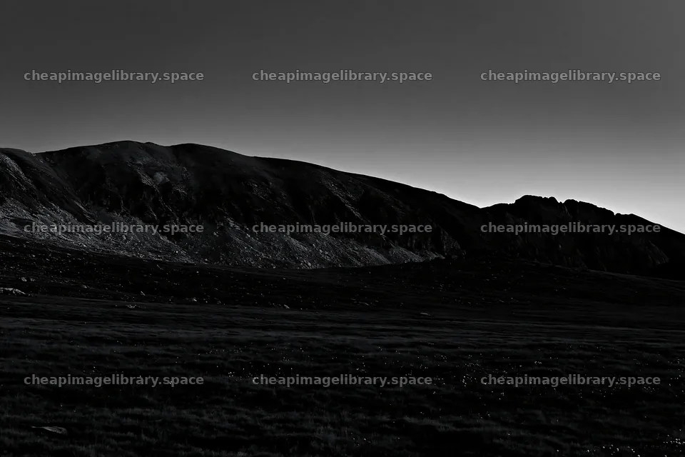 Moonrise over meadow with mountains in silhouette – image library 9722x6480