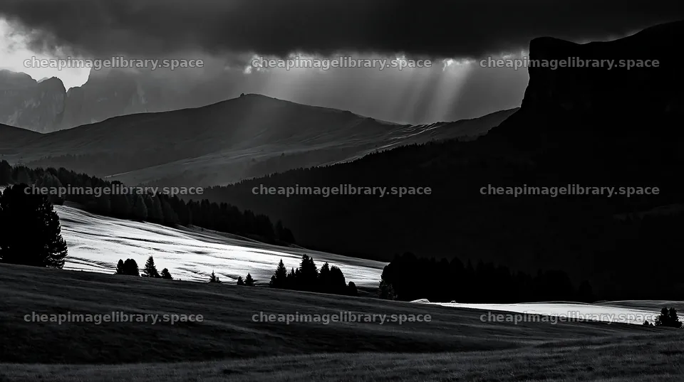 Sunbeams illuminate Alpe di Siusi meadow under dark clouds – image library 10608x5938