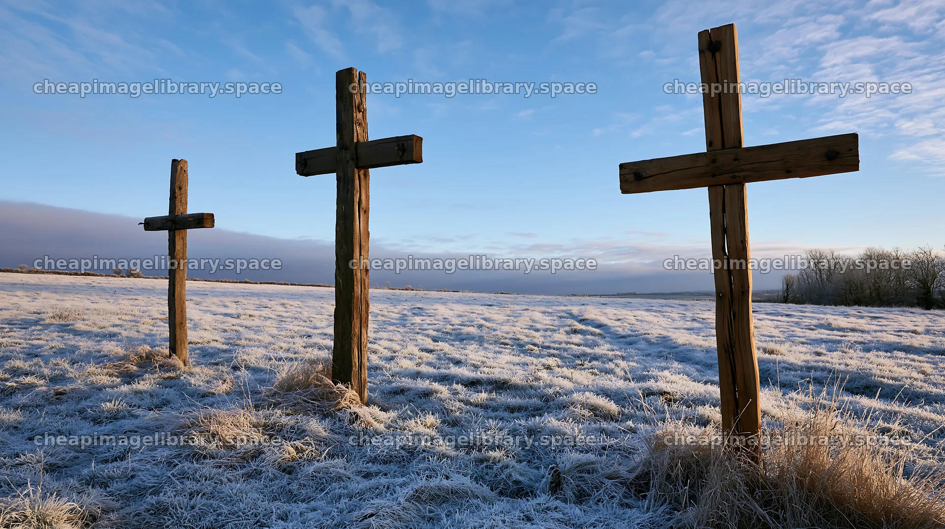 Rustic crosses standing in winter meadow – image library 10608x5938