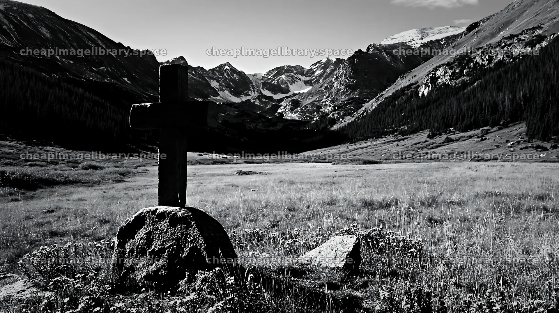 Stone Christian cross in alpine valley meadow – image library 10608x5938