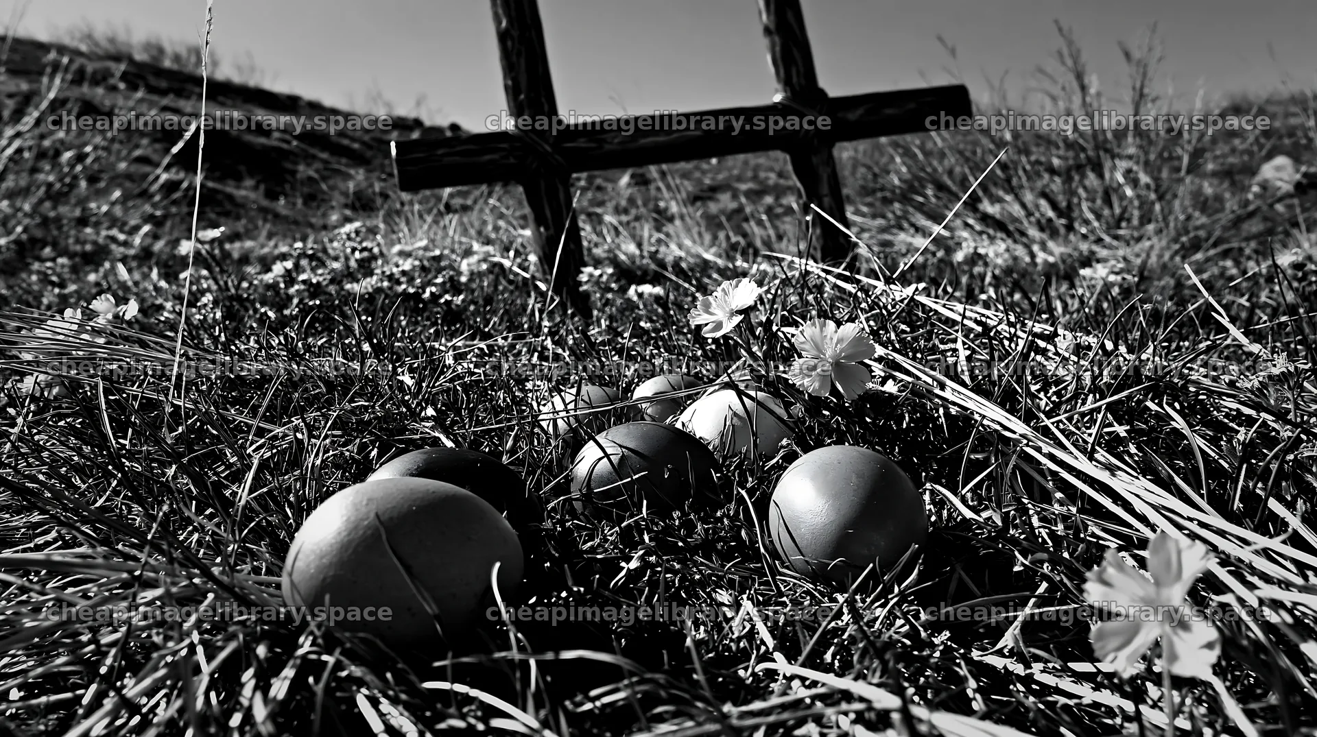 Bronze Christian cross in a meadow during Christmas season – image library 10608x5938