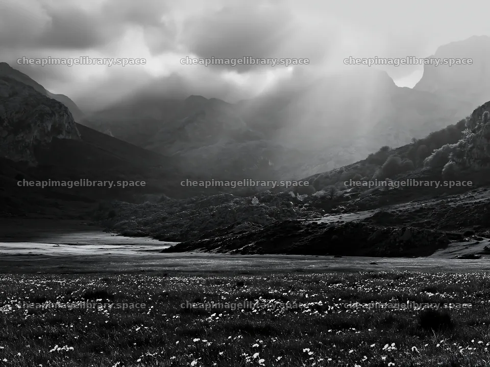 Sunrays breaking through clouds over Picos de Europa meadow – image library 9174x6866
