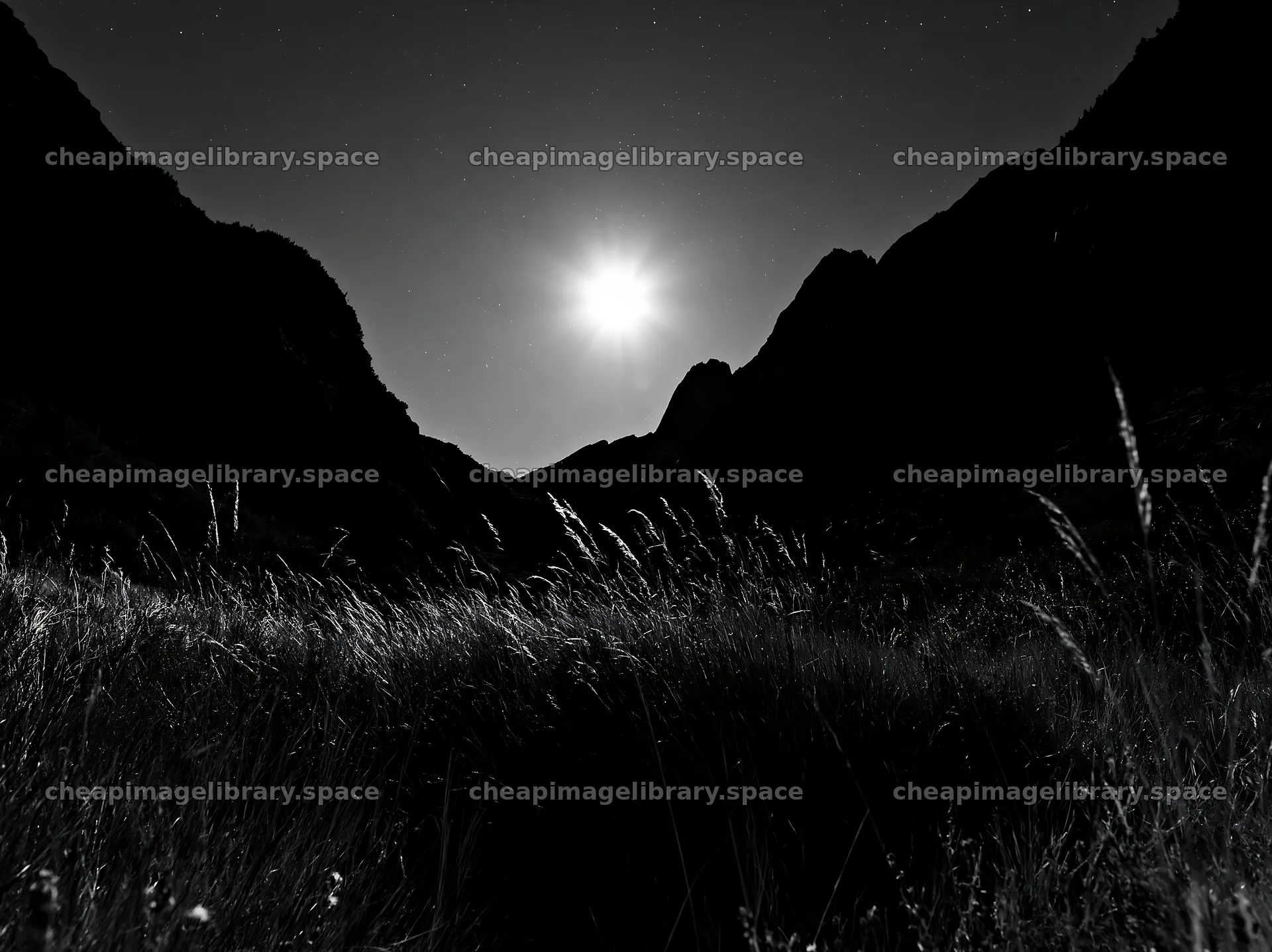 Meadow under crags with moonlight shining down – image library 9174x6866